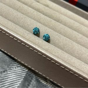 Blue stud earrings.